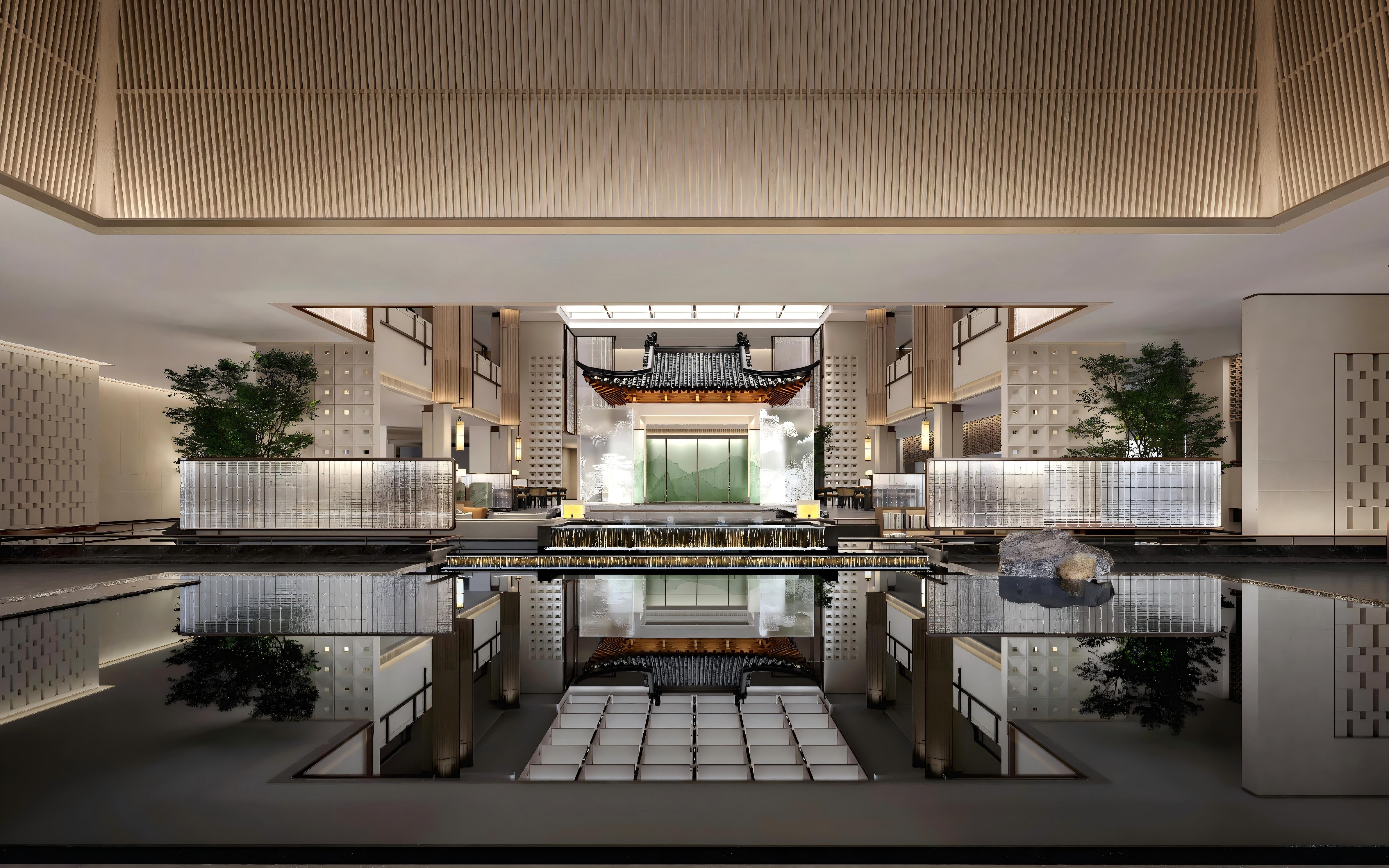 Interior of a modern building with a pool and traditional architectural elements.