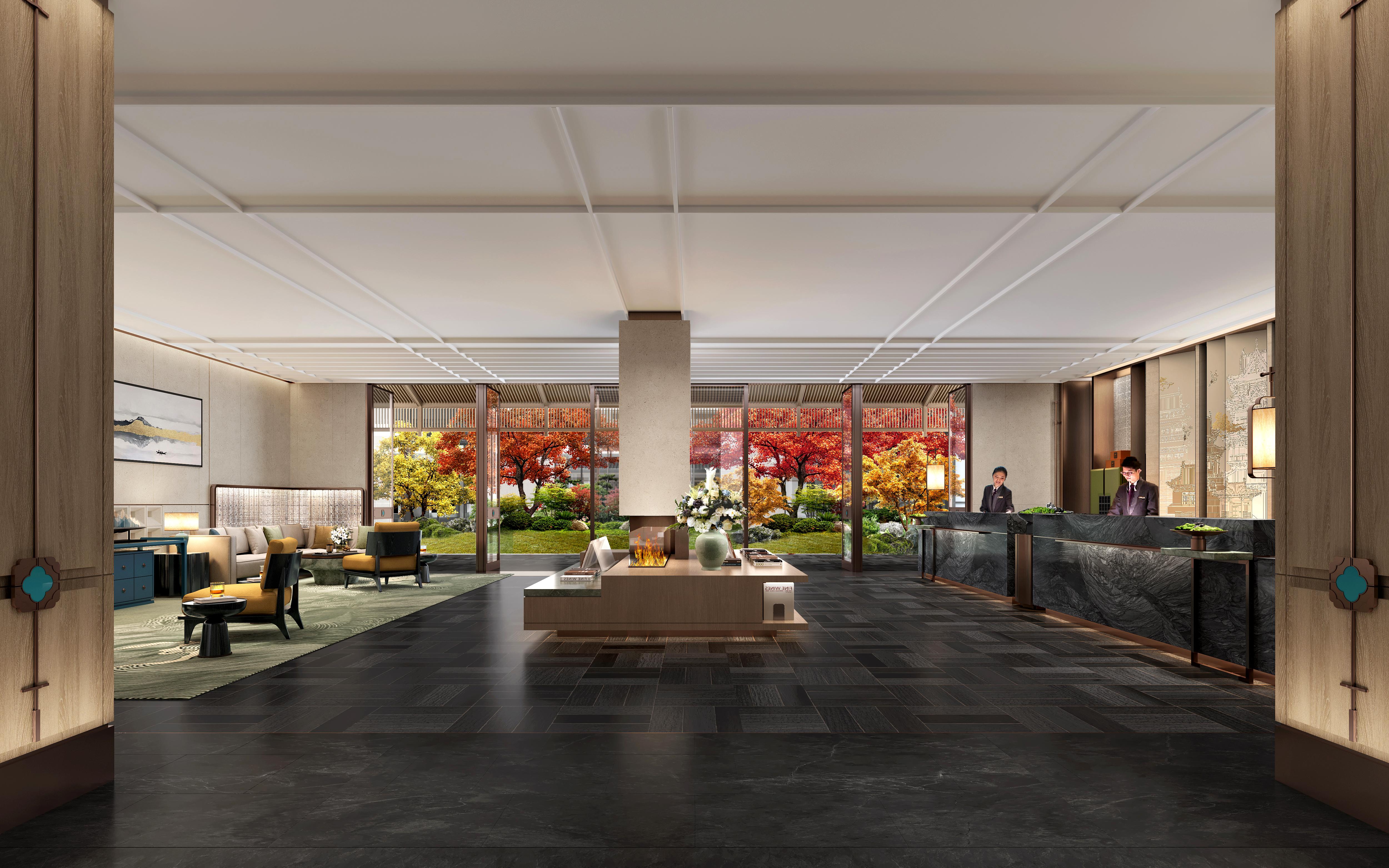 Modern interior of a hotel lobby with seating area and large windows.