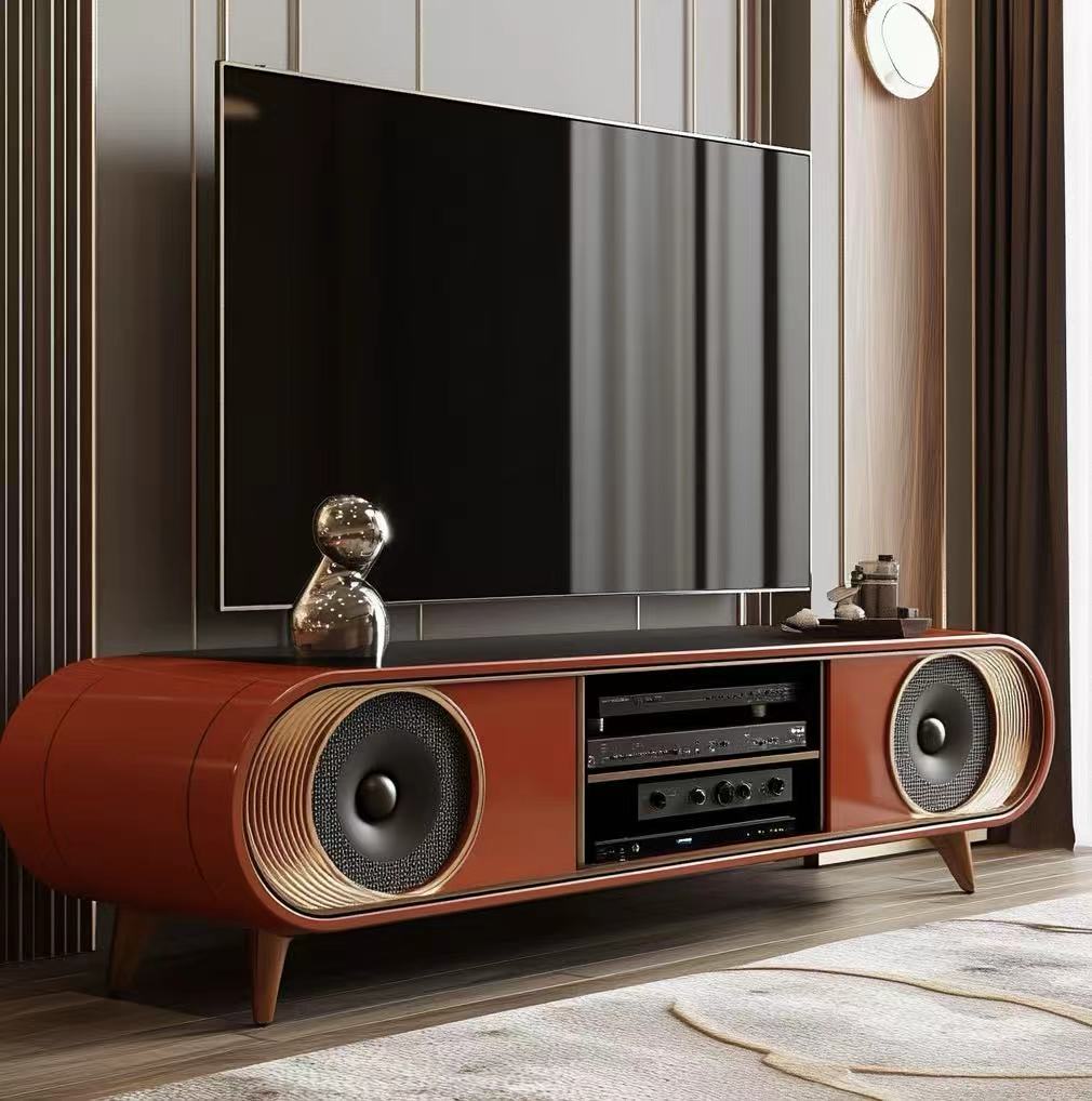 Modern entertainment console with speakers and a television in a room.