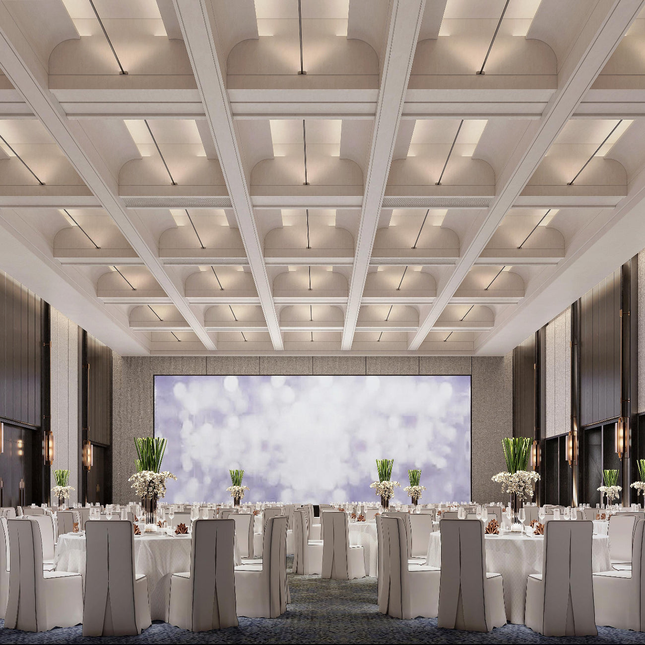 Large conference room with tables, chairs, and a large screen on the wall.
