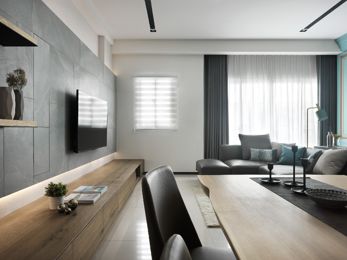 Modern living room with gray sofa, wooden coffee table, and decorative elements.