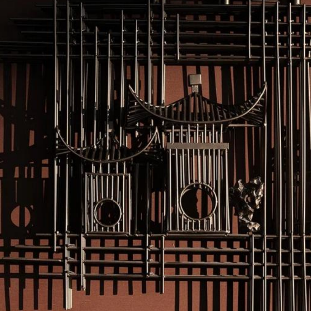 Decorative metalwork with intricate designs on a dark background