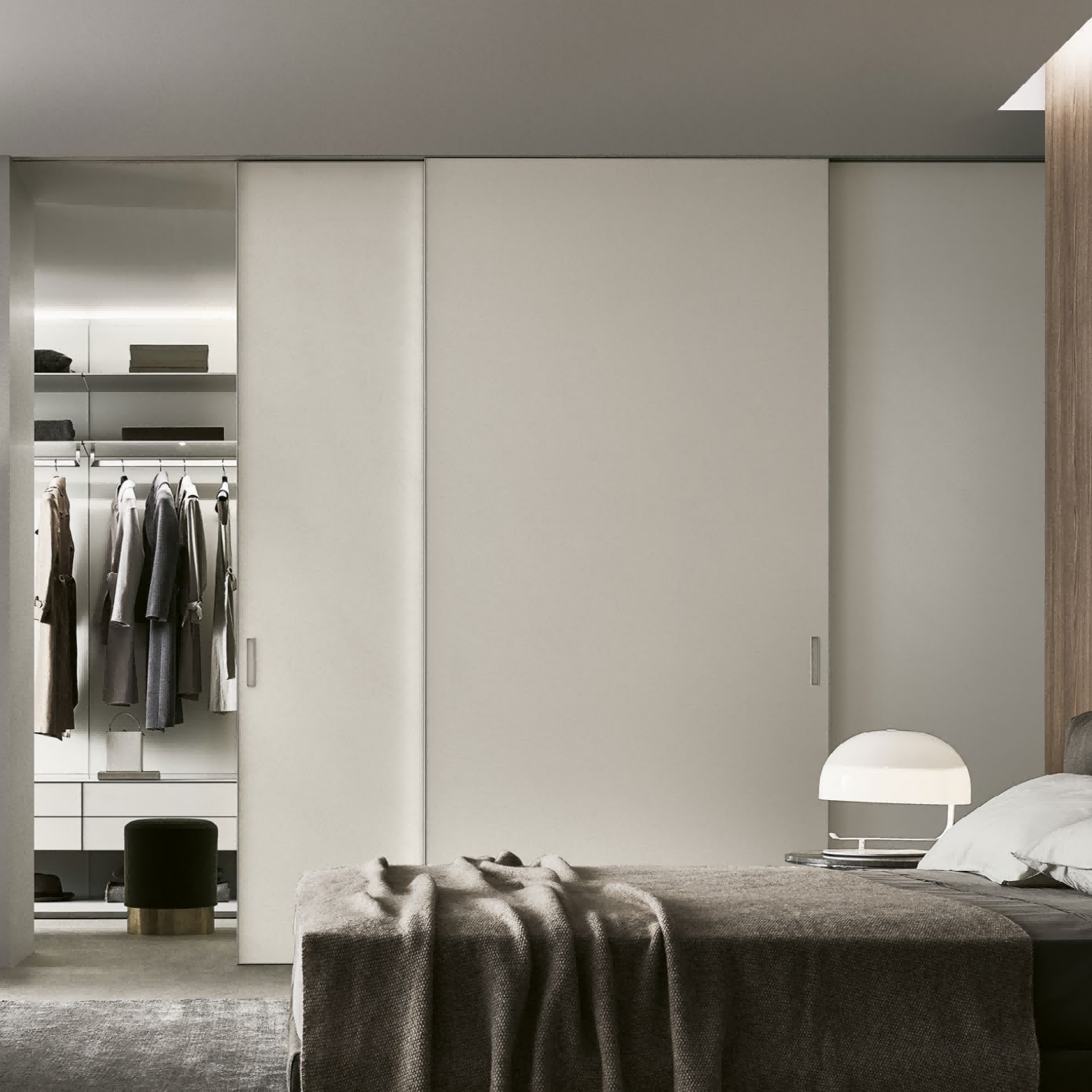 Modern bedroom with wardrobe and bed in a minimalistic design.