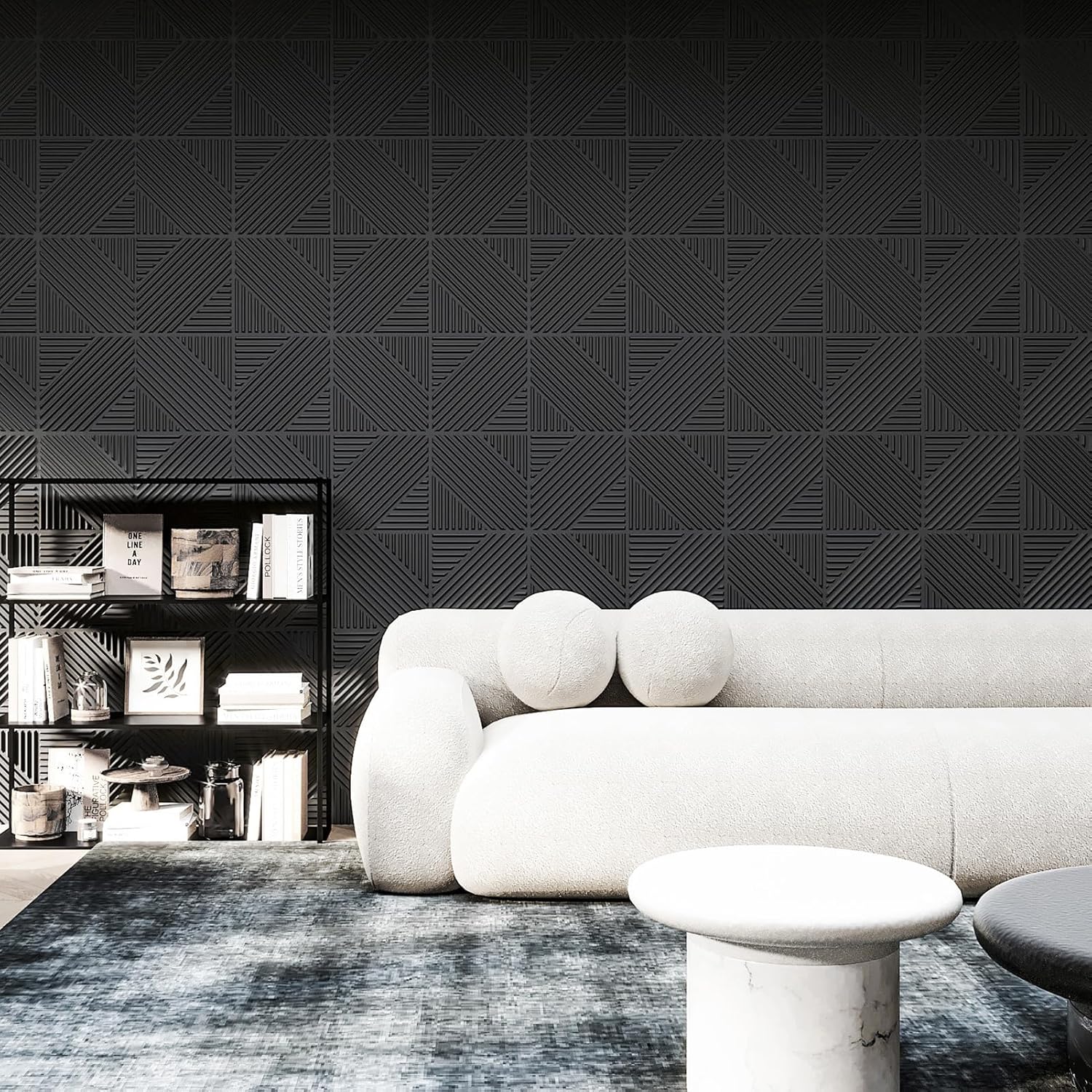 Modern living room with a white sofa against a black geometric patterned wall.