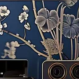 Modern entertainment console with floral design against a wooden wall.