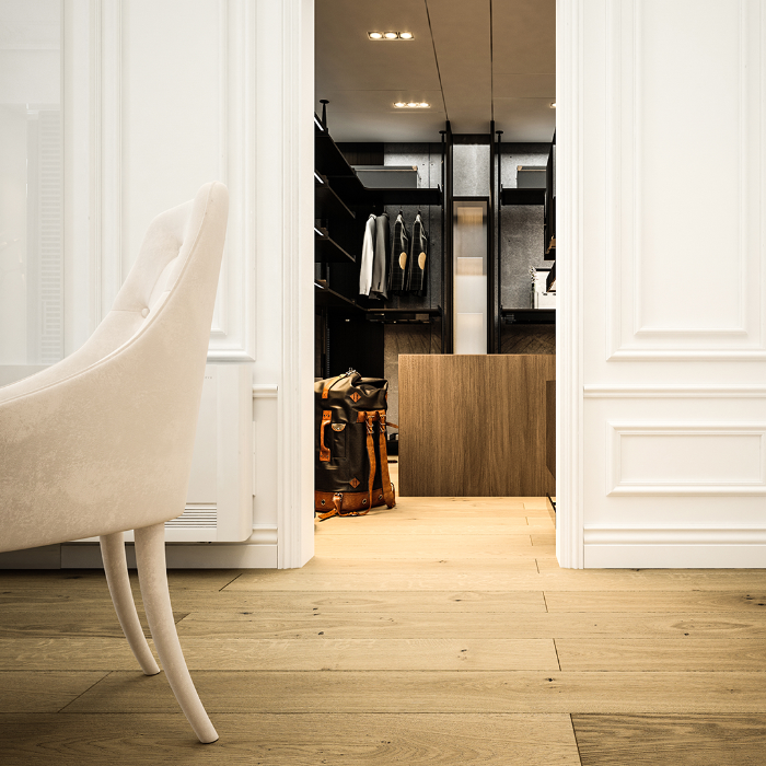 Modern interior with a chair and open door revealing a closet.