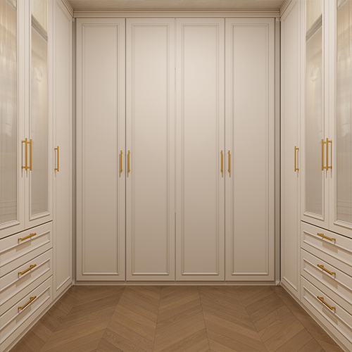 Beige wardrobe with gold handles in a room with wooden flooring