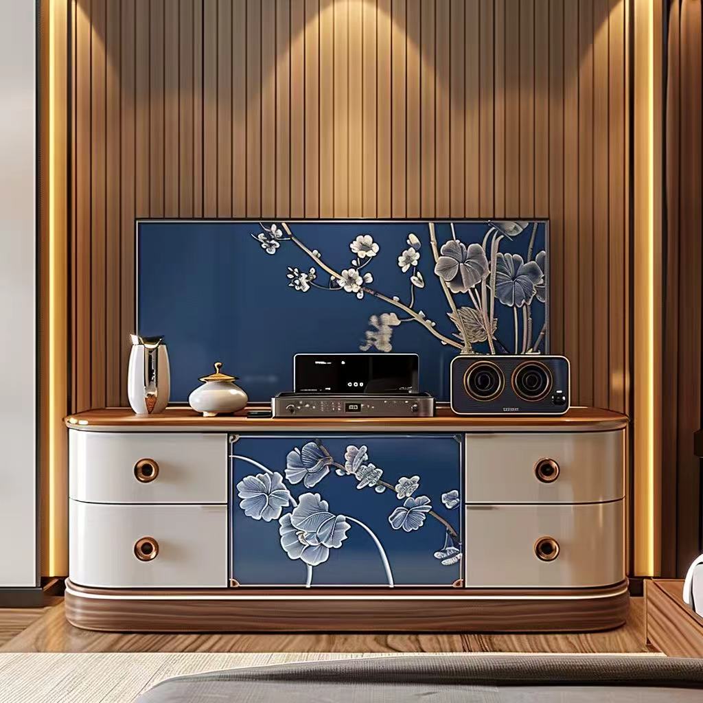 Modern entertainment console with floral design against a wooden wall.