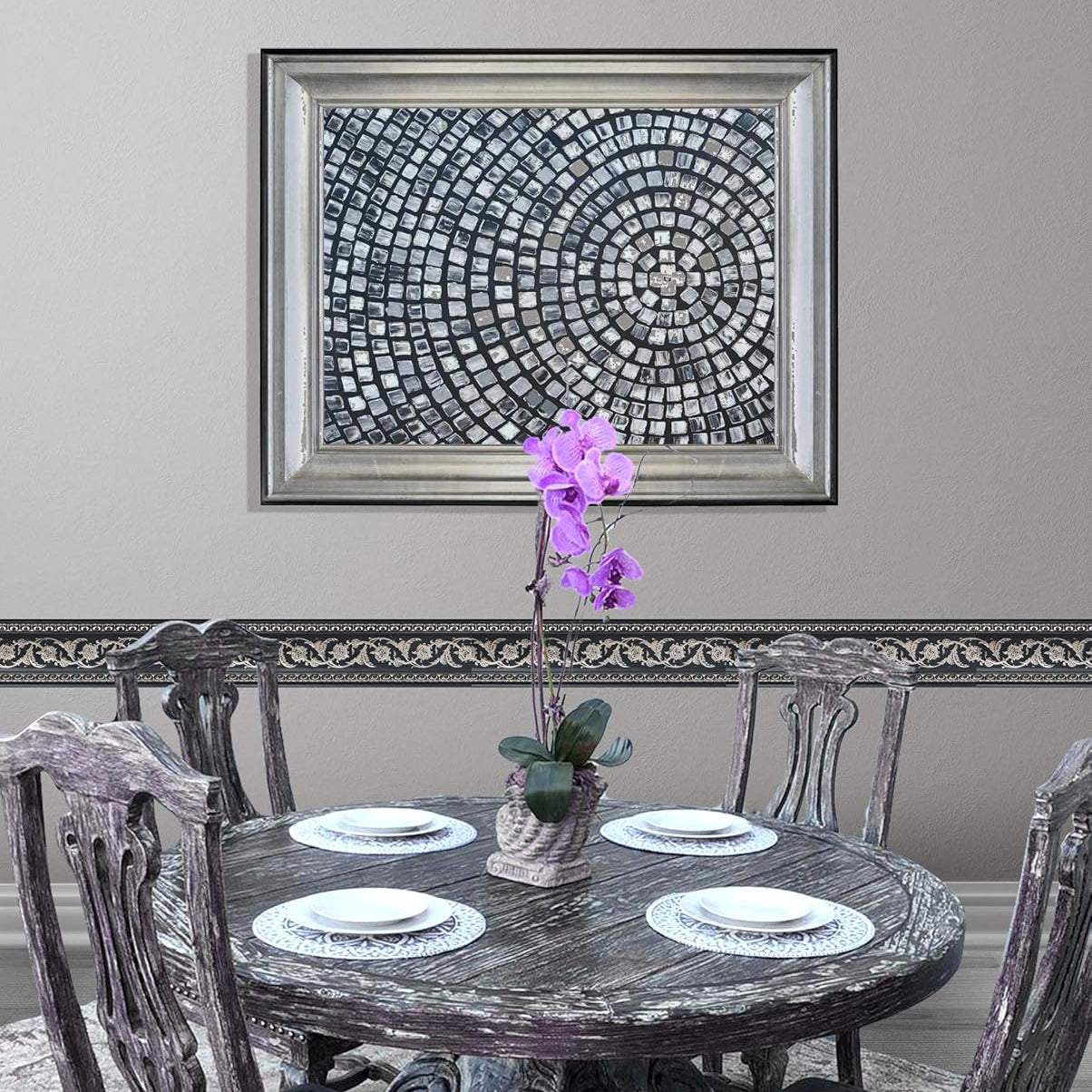 Dining room with a round wooden table and chairs, featuring a decorative wall art piece.