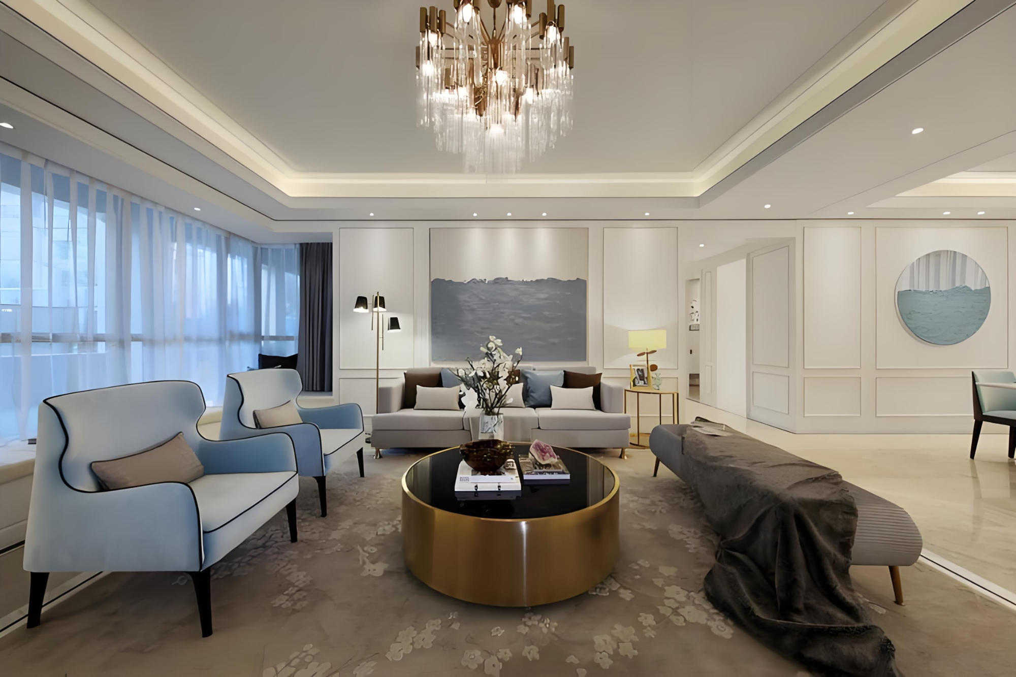 Modern living room with gray sofa, blue armchairs, and a round coffee table.