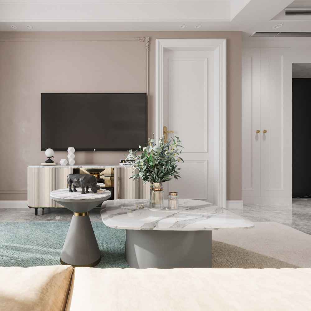 Modern living room with a TV, coffee table, and decorative items.