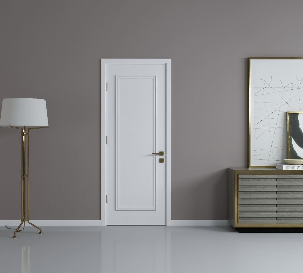 White door in a room with a lamp and a piece of furniture against a gray wall.