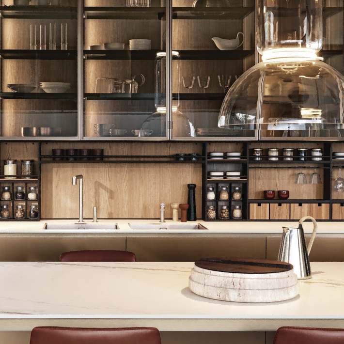 Modern kitchen with wooden shelves, white countertops, and pendant lights.