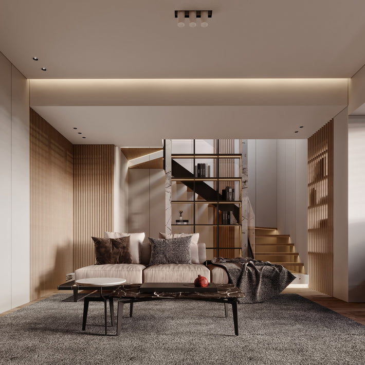 Modern living room with a sofa, coffee table, and bookshelf.