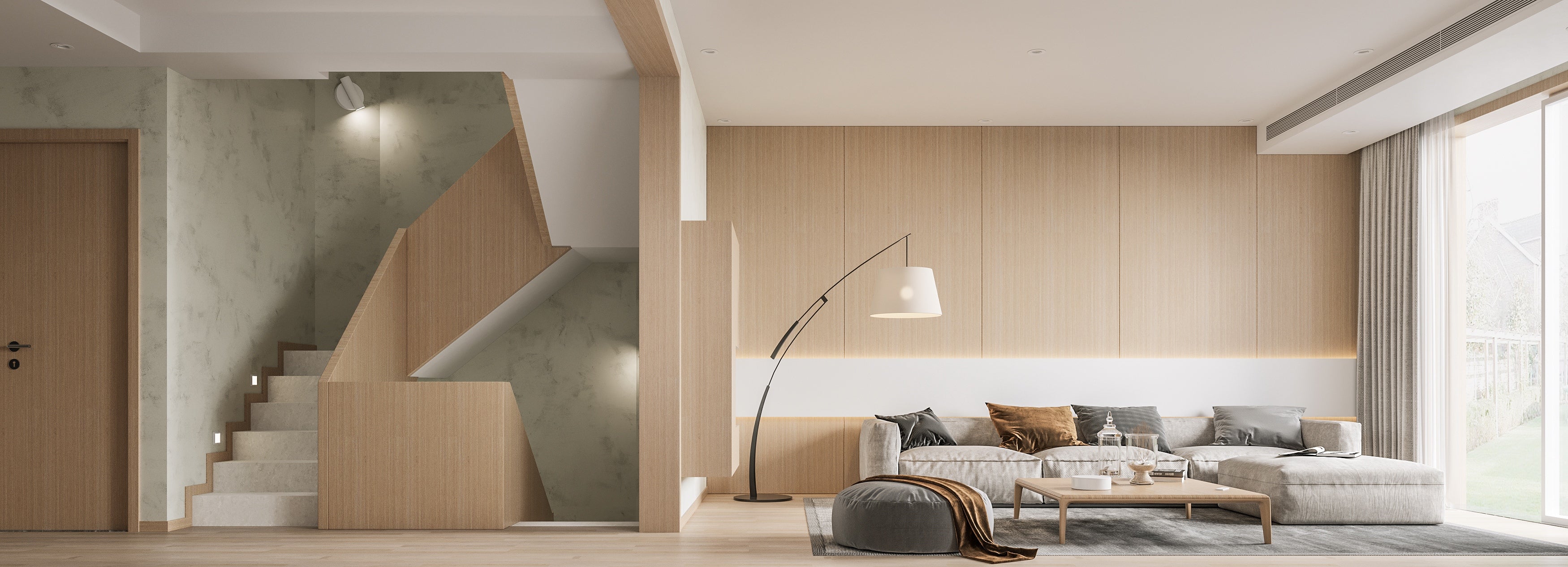 Modern living room with a staircase and large windows.