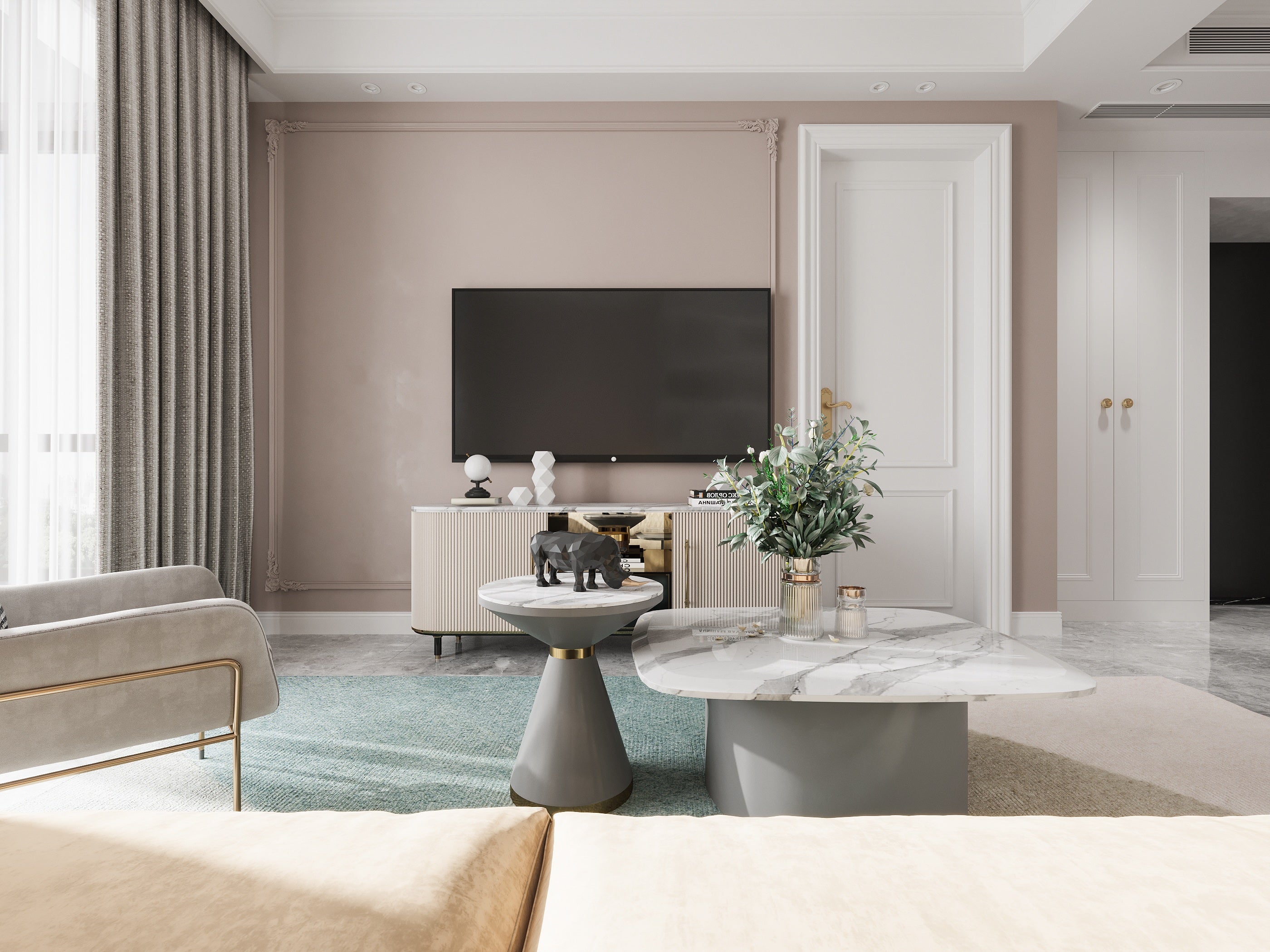 Modern living room with a television, coffee table, and decorative items.