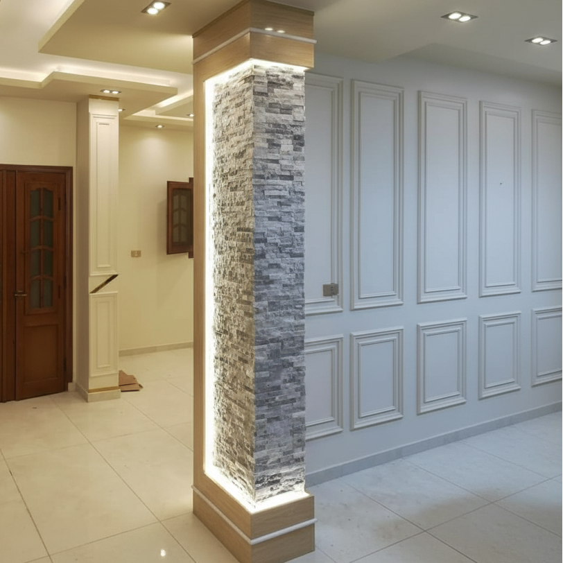 Modern interior design with a wooden door, stone column, and paneled walls.