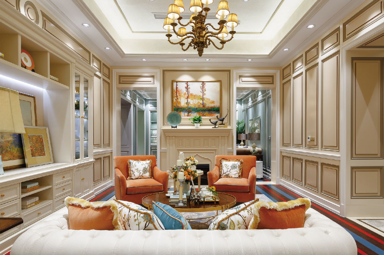 Luxurious living room with beige walls, orange armchairs, and a chandelier.