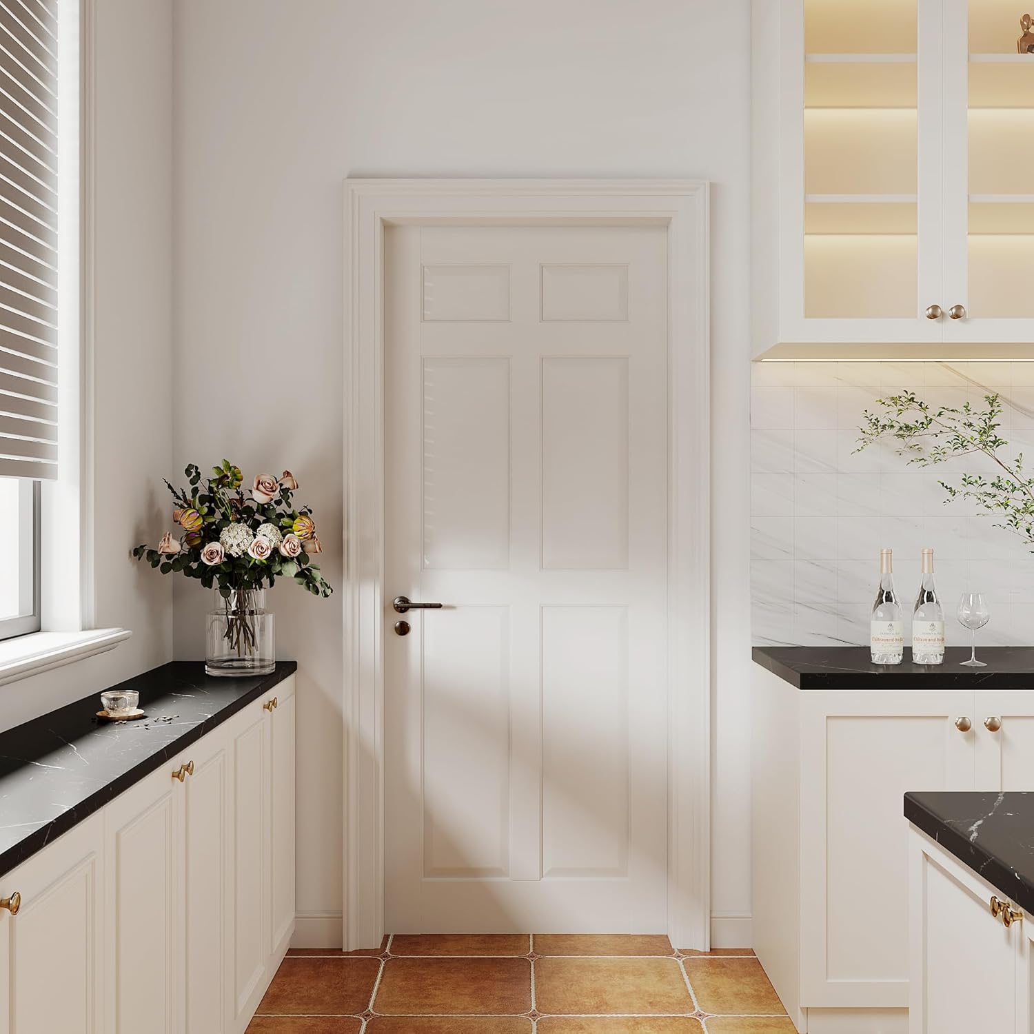 Modern kitchen interior with white cabinets, black countertops, and a vase of flowers on a windowsill.