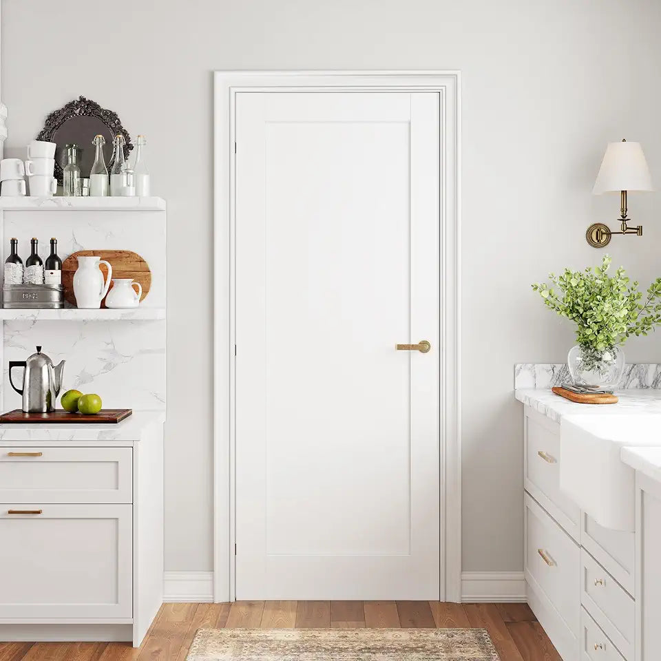 Modern kitchen with white cabinets, marble countertops, and a central door.