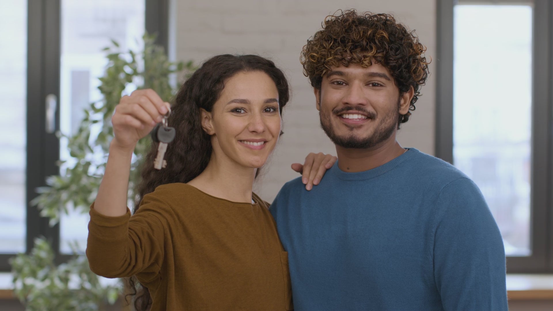 happy-young-middle-eastern-couple-showing-keys