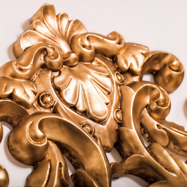 Decorative gold leaf design on a white background